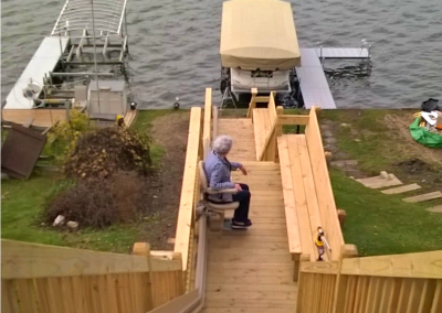 outdoor stair lift leading to lake in backyard of home